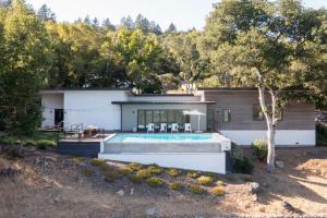 a house with a swimming pool in a yard at Chardonnay by AvantStay Modern Private Haven in Sonoma Infinity Pool w Valley Views in Sonoma