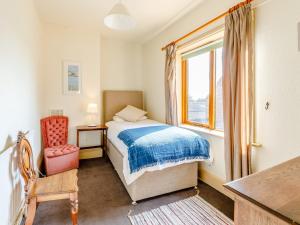 a bedroom with a bed and a window and a chair at 8 Bed in Abbots Bromley 79321 in Abbots Bromley