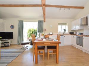 a kitchen and dining room with a wooden table at 1 Bed in Hilton 76518 in Tutbury