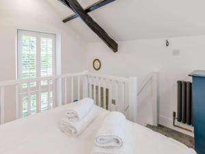 a white bedroom with towels on a bed at 1 Bed in Bude 75045 in Kilkhampton