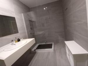 a white bathroom with a sink and a shower at Centre Point, Malta's most central in Pieta +30 photos