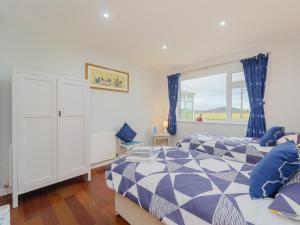 a bedroom with two beds and a window at 5 Bed in Mold 79345 in Llanferres