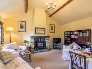 a living room with a fireplace and a tv at 2 Bed in Harrogate 79165 in Weeton