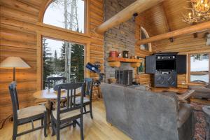 a living room with a table and a stove at Snowdrift Cabin by AvantStay Breathtaking Home w Prime Ski Access Hot Tub in Telluride