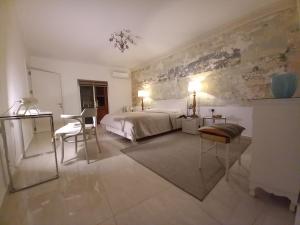 a bedroom with a bed and a table and chairs at Centre Point, Malta's most central in Pieta