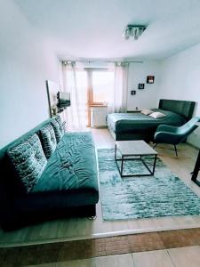 a living room with two couches and a coffee table at Apartment Vlašićka Priča in Vlasic