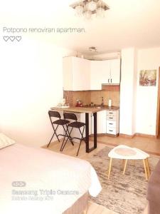 a kitchen with a table and chairs in a room at Apartment Vlašićka Priča in Vlasic