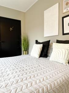 um quarto com uma grande cama branca e 2 almofadas em Bed & Breakfast Waterpoort - incl licht ontbijt em Sneek