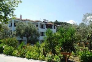 a large white building with trees and plants at Villa Maro in Skopelos Town