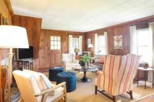 a living room with a couch and chairs and a tv at Whitney by AvantStay Private Berkshires Estate in Sheffield