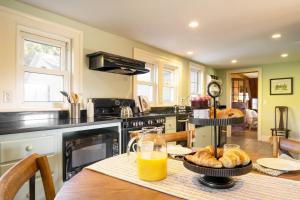 a kitchen with a table with a jug of orange juice at Whitney by AvantStay Private Berkshires Estate in Sheffield