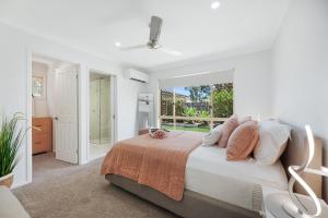 a bedroom with a bed and a large window at Maroochy Magic Family Coastal Getaway in Maroochydore