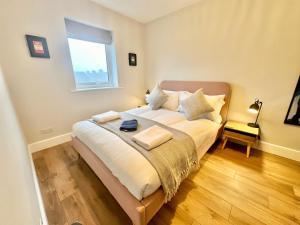 a bedroom with a large bed with a window at Barbican Loft - with Free parking in York