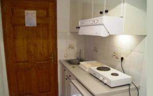 a kitchen with a stove and a sink and a door at Villa Maro in Skopelos Town
