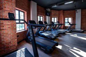 a row of treadmills in a gym with a brick wall at Spacious studio in Perivolia tou Trikomou