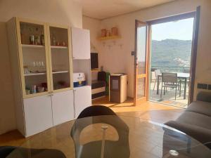 a living room with a couch and a table at Casa Ulivo con Piscina in Diano Castello