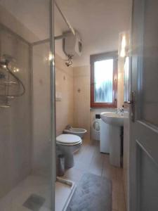 a bathroom with a toilet and a sink and a shower at Casa Ulivo con Piscina in Diano Castello