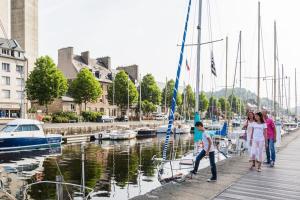 a group of people standing on a dock with boats at 3 bedroom apartment with terrace - Saint-Brieuc in Saint-Brieuc