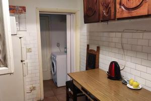 a kitchen with a table and a sink and a refrigerator at Casa nel cuore di Firenze. in Florence