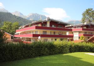 a large building with mountains in the background at Ski-In/Ski-Out Appartements Augasse by Schladming-Appartements in Schladming
