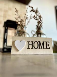 a home sign with a heart on a table at Mansarda antica Milano in San Giuliano Milanese +16 photos