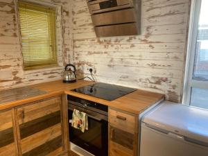 a small kitchen with a stove and a sink at Central Sea View maisonette in Hastings