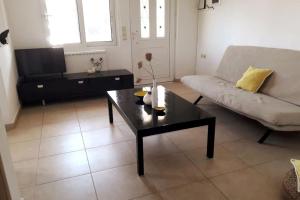 a living room with a couch and a coffee table at Elia - seaside place in Agios Nikolaos