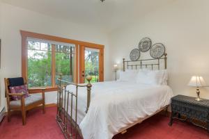 a bedroom with a bed and a chair and a window at Goss Lake Chalet by AvantStay Lakefront w Dock in Langley