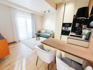 a living room with a table and chairs in a room at NEW Ana Design City Center Apartments in Pula +10 photos