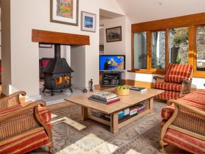 a living room with a fireplace and a table at 2 Bed in Talybont-on-Usk BN132 in Talybont