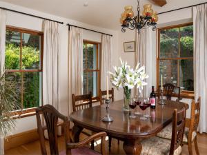 a dining room with a wooden table with wine glasses at 2 Bed in Talybont-on-Usk BN132 in Talybont