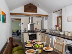 a kitchen with a table with plates of food on it at 2 Bed in Pengenffordd BN366 in Cathedine