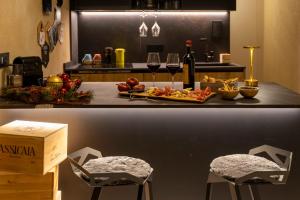a counter with a plate of food and glasses of wine at MALU' Exclusive Retreat in Pescocostanzo