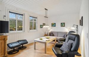 a living room with a couch and a table at Pet Friendly Home In Fan With Wifi in Fanø