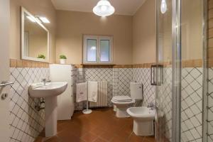 een badkamer met 2 toiletten, een wastafel en een douche bij Casa Amedeo in Lucca +8 foto's