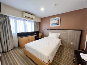 Postel nebo postele na pokoji v ubytování Hallmark Express Hotel