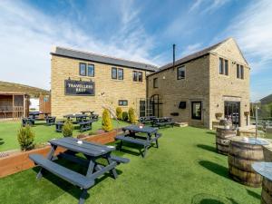 a patio with picnic tables in front of a building at 1 bed property in Holmfirth 82194 in Meltham