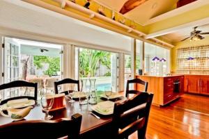 a dining room with a table and some chairs at Casa de Rosalie by AvantStay Great Location w Pool BBQ Outdoor Dining Month Long Stays Only in Key West