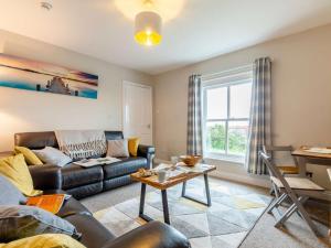 a living room with a couch and a table at 2 Bed in Kilnsea 83428 