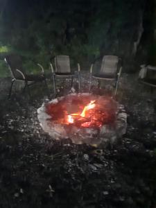 a fire pit with chairs and chairs around it at Family Hotel Maia - Cемейная гостиница Майя in Dashbashi