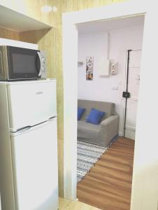 uma sala de estar com um frigorífico e um sofá em Alfama Valle em Lisboa