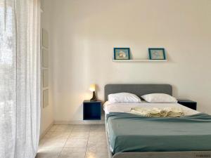 a bedroom with a bed and a lamp and a window at BLife Aerya private rooms in Faro