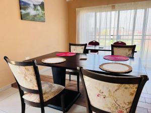 a dining room with a table with chairs and a tableablish at Mphatlalatsane BnB in Maseru
