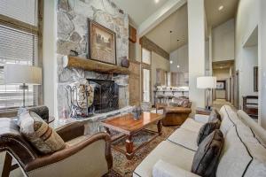 a large living room with a stone fireplace at Mont Cervin 33 by AvantStay Luxury Ski in Ski out home in Park City in Park City