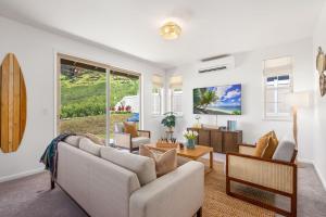 a living room with a couch and a table at Alaula by AvantStay Gated Security Home w Valley Ocean Views in Waianae