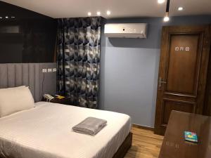 a bedroom with a bed with a bag on it at Royal Garden Hotel & Restaurant in Cairo