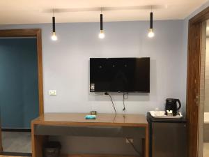 a room with a desk with a television on a wall at Royal Garden Hotel & Restaurant in Cairo