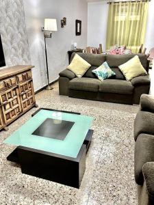 a living room with a couch and a coffee table at Esplús Casa Rural in Binéfar