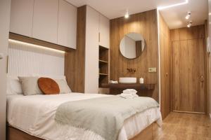 1 dormitorio con cama blanca y espejo en Suite JC1 CHIC, en Murcia