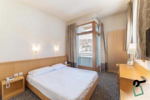 a hotel room with a bed and a window at HOTIDAY Hotel Sestriere in Sestriere
